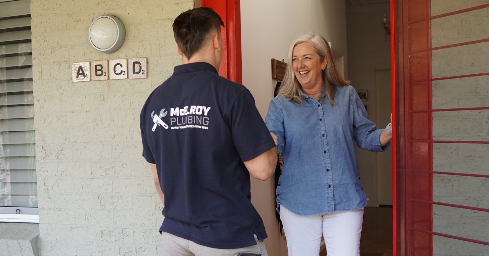McElroy plumber at a customer's front door